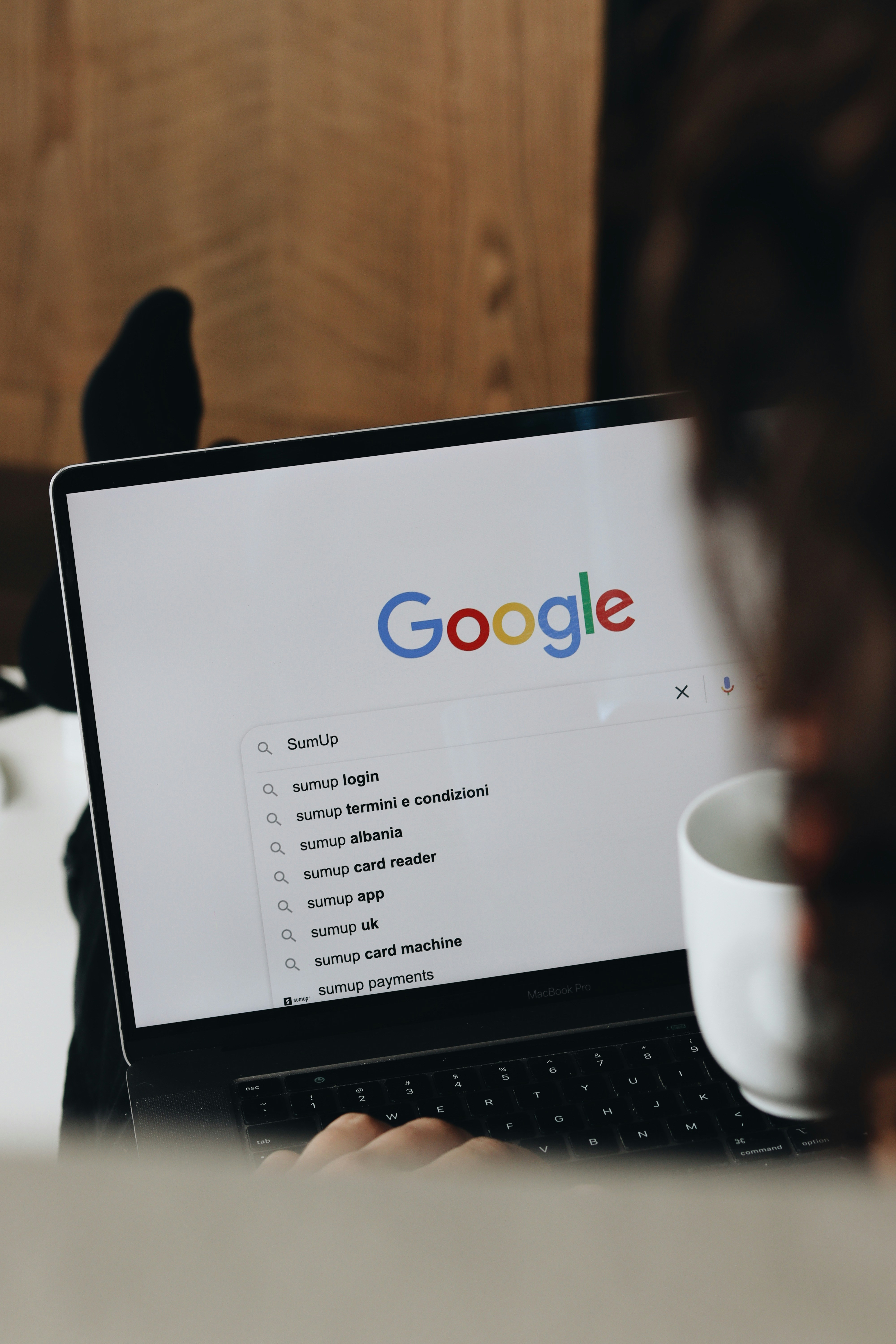 User typing in Google search with business suggestions appearing, symbolizing improved SEO visibility
